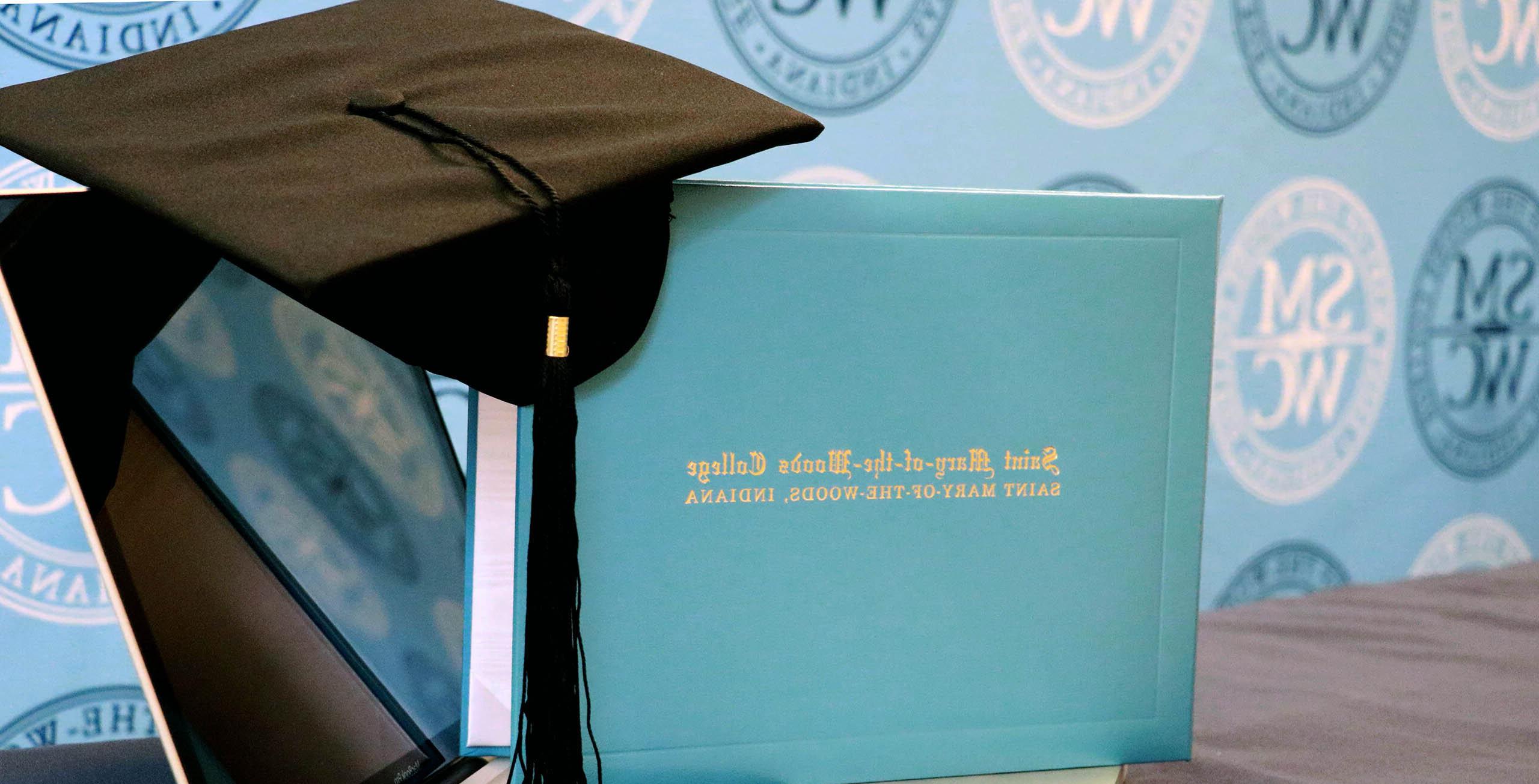 SMWC diploma and cap sitting on a laptop